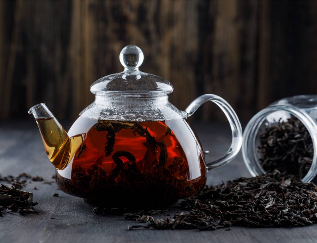 Glazen theepot met ontvouwend oolongblad